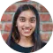 Profile picture of a smiling woman against a brick wall, symbolizing a team member or individual